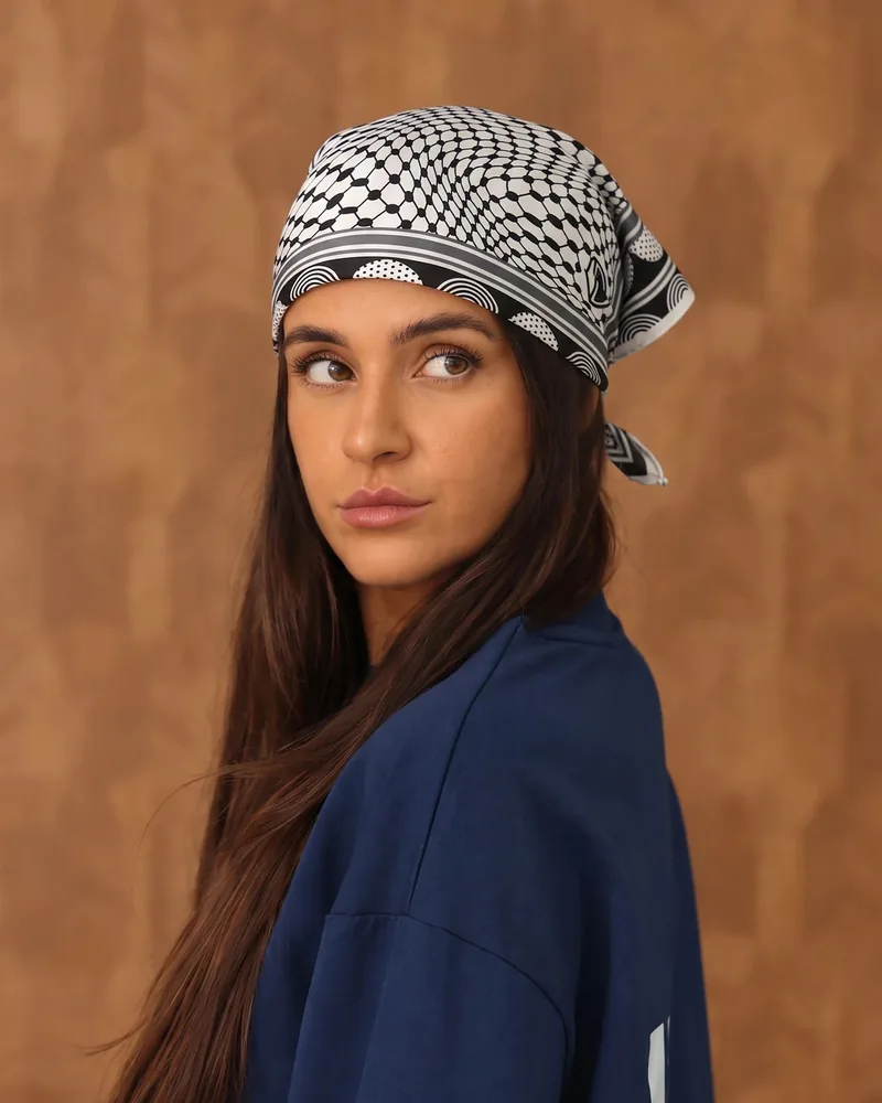Roots silk bandana in black, worn as a headscarf